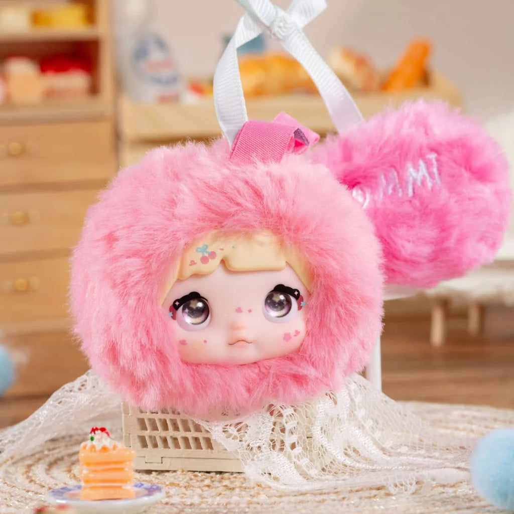 Nommi V9 100% Sweetness Series Blind Box featuring a cute pink fuzzy doll with a playful expression.