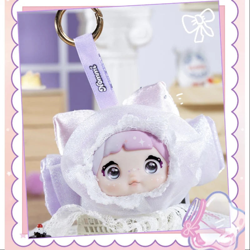 Nommi V9 100% Sweetness Series Blind Box featuring a cute doll in a flower costume with a keychain.